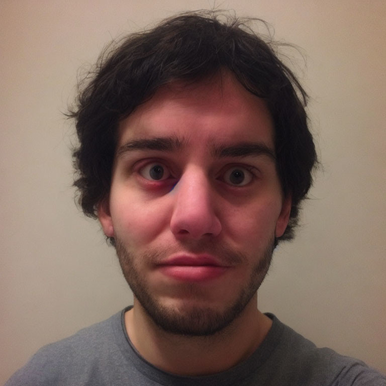 Portrait of Young Man with Black Curly Hair and Dark Eyes