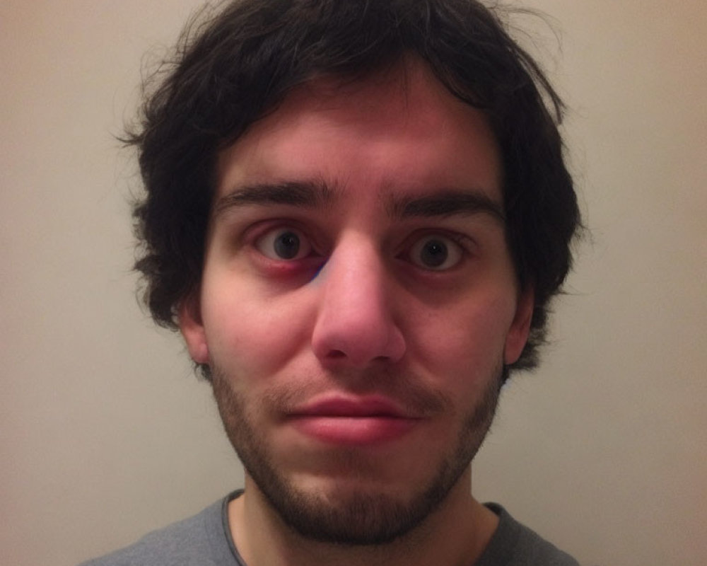 Portrait of Young Man with Black Curly Hair and Dark Eyes