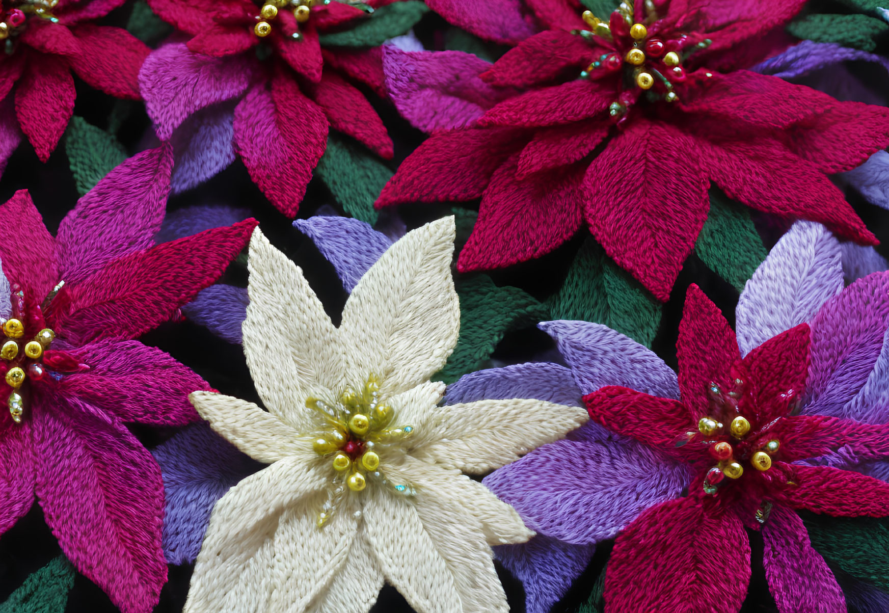 Vibrant fabric poinsettias in red, white, purple, green leaves, and golden