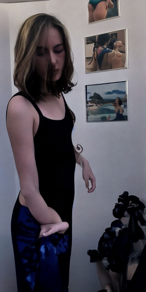 Woman in Black Top and Blue Skirt Contemplating Beside Wall with Beach Photo