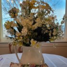 Elaborate floral arrangement in decorative vase with vibrant colors