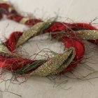 Festive Christmas wreath with red and gold baubles and pine branches