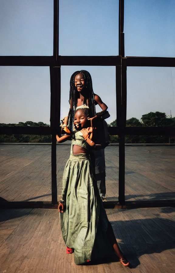 Smiling woman and child against geometric backdrop