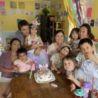 Young girls in princess attire at fancy birthday party with pink decorations