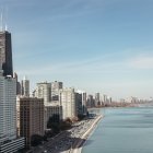 Urban skyline with high-rise buildings by canal and boats on water