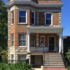 Victorian-style pink and cream house with ornate details and arched windows