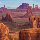 Desert landscape with sandstone buttes and rock formations at sunrise or sunset