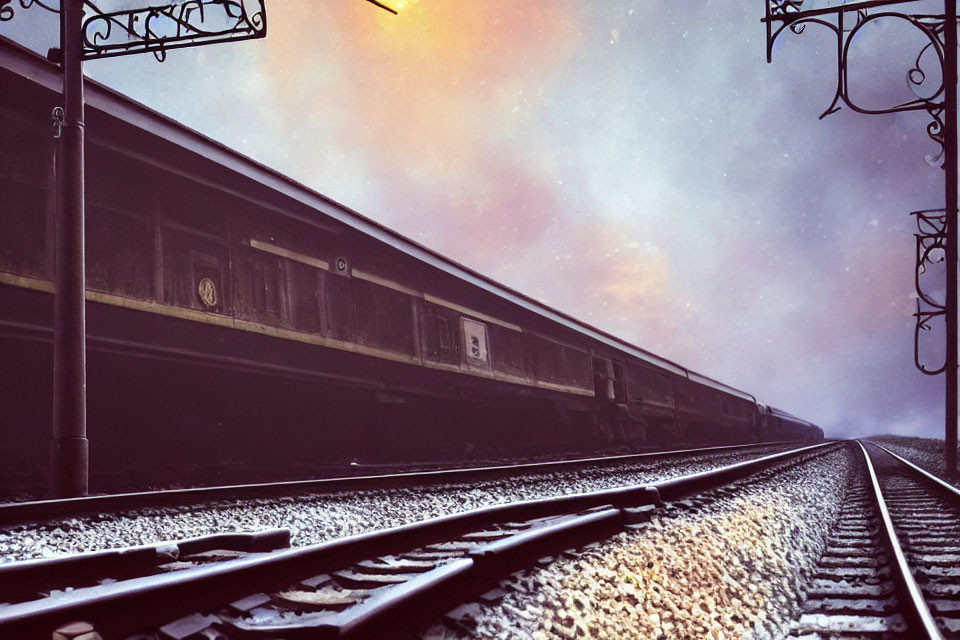 Vintage steam locomotive at train station under dynamic sky.