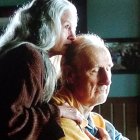 Elderly couple sharing intimate moment in tender embrace