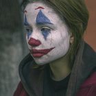 Colorful Clown Makeup with Teardrop Detail and Green Hairpiece