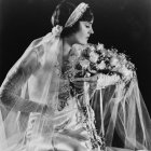 Woman in white dress with bouquet of flowers in monochromatic setting