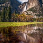 Colorful Autumn Waterfall Painting with Rocky Cliffs