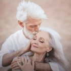 Older Couple in Vintage Attire with Serious Expressions