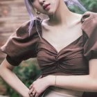 Ethereal woman with flower crown in floral garden surrounded by butterflies