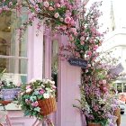 Floral-themed whimsical doorway with pastel colors and flying birds