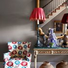 Woman in Red Dress on Colorful Staircase in Vibrant Interior