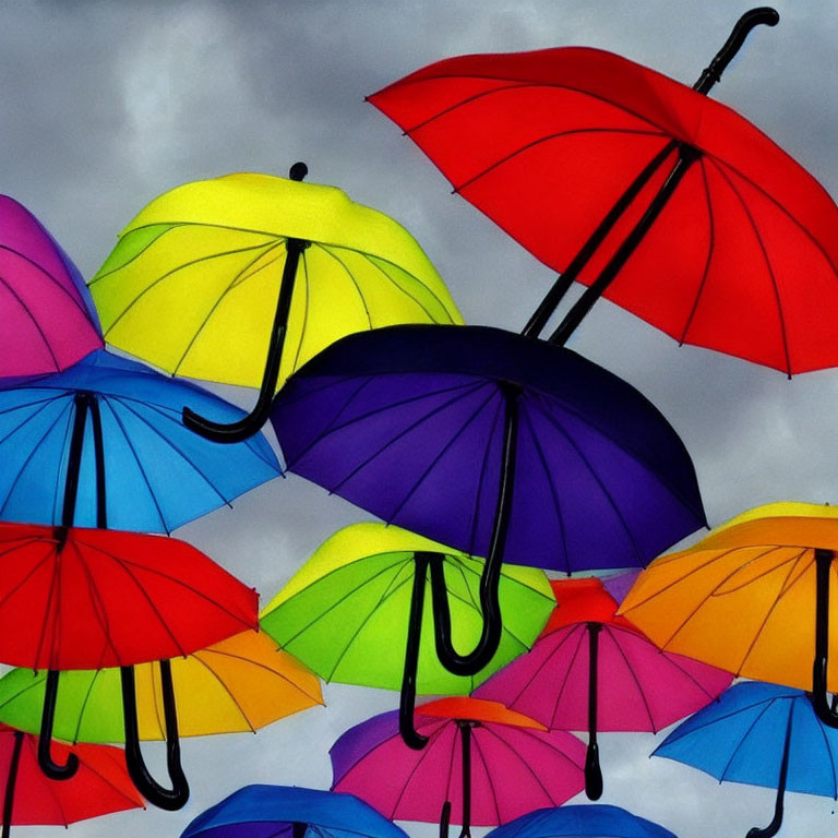 Vibrant multicolored umbrellas under cloudy sky