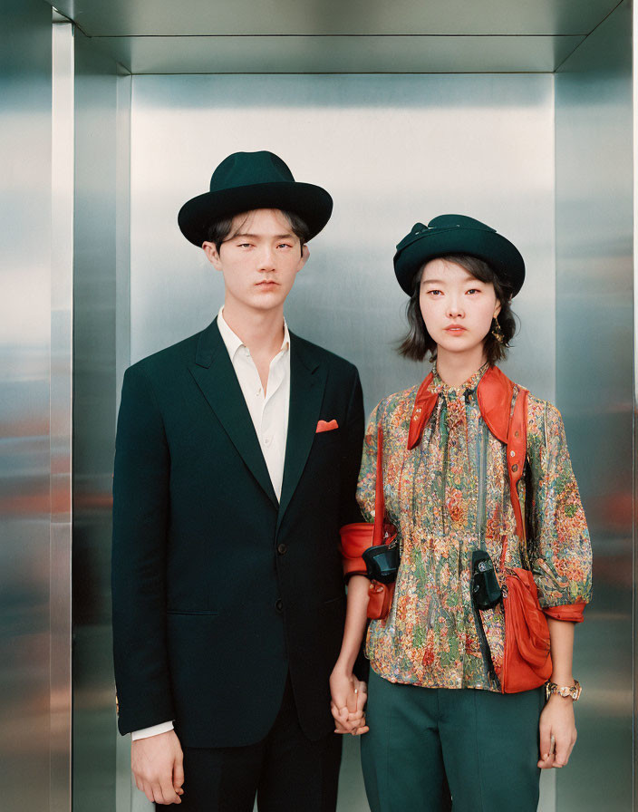 Stylish man and woman in elevator with hats and distinctive attire