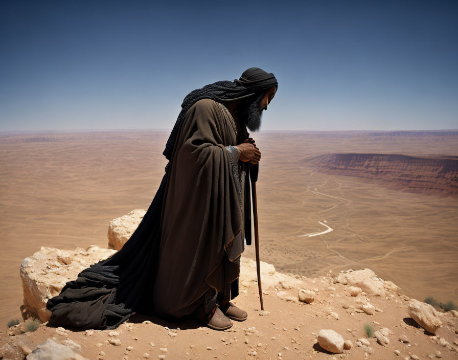 Robed Figure with Staff Overlooking Desert Cliff