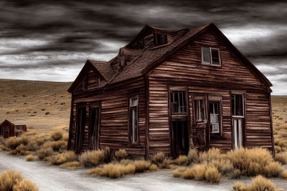 Abandoned wooden house under dark, cloudy sky