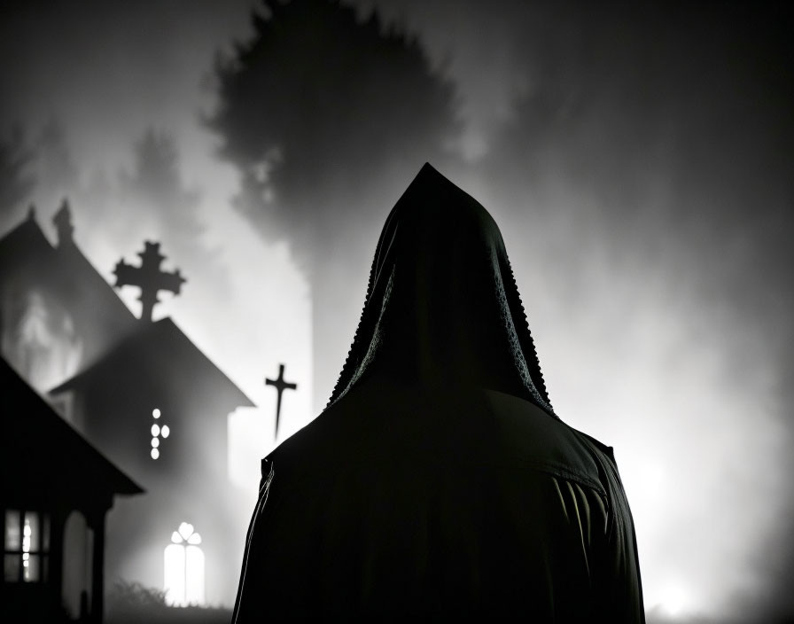 Hooded figure in front of misty, illuminated church at night