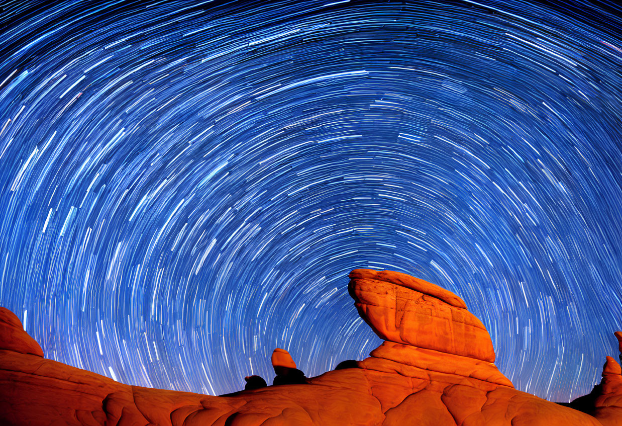 Circular Star Trails Over Orange Rock Formations at Night