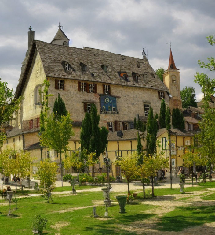 Medieval stone building with clock in serene village square