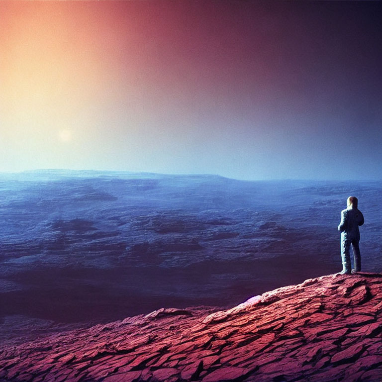 Person standing on rocky alien landscape under colorful sky with large sun