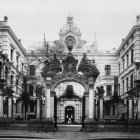 Person in Blue Jacket by Flower-Adorned Building with Pigeons on Cobbled Street