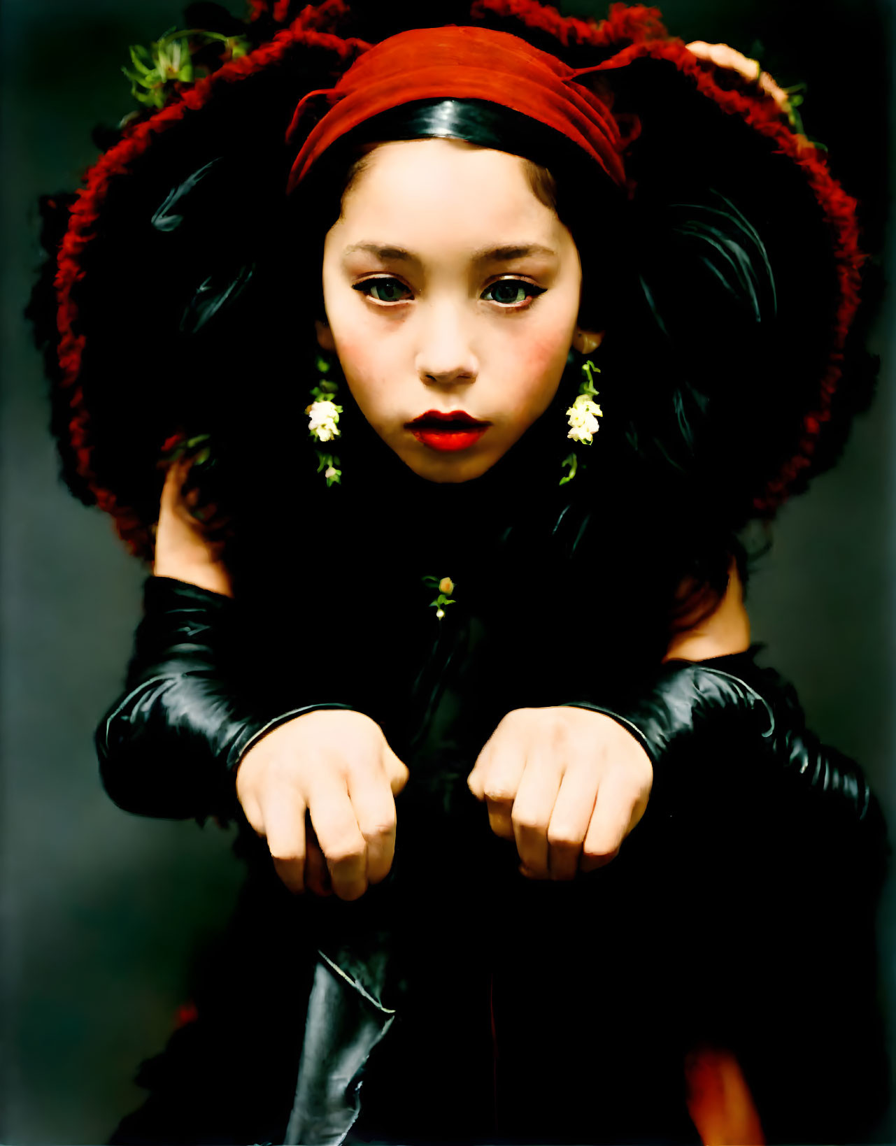 Young girl in dramatic outfit with bold accessories