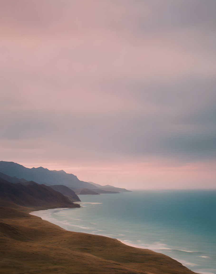 Serene Coastal Landscape with Gentle Waves and Mountains