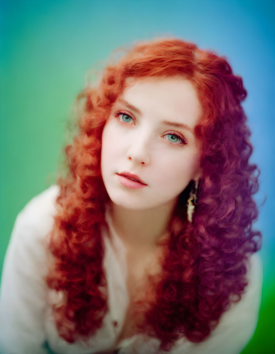 Portrait of Woman with Curly Red Hair and Sea-Green Eyes on Blue-Green Background