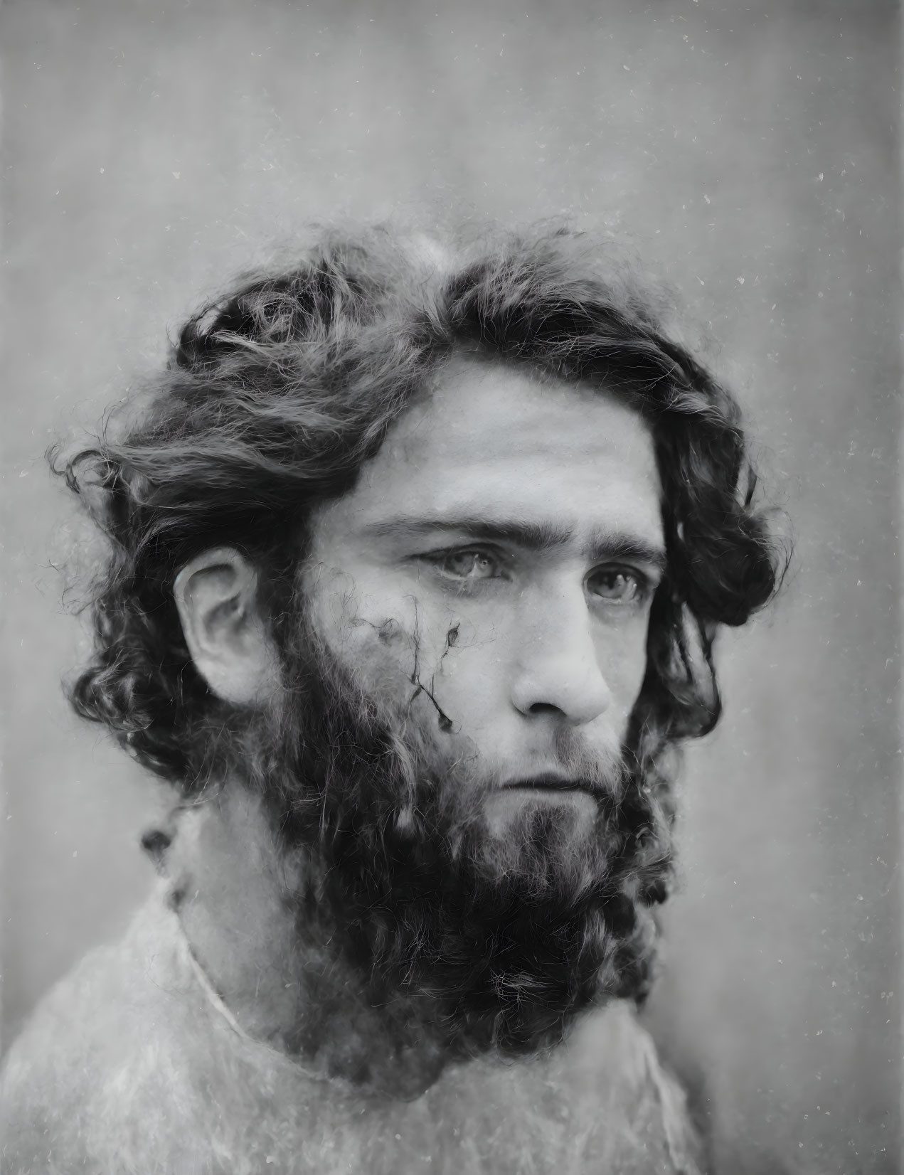 Black-and-white portrait of a contemplative young man