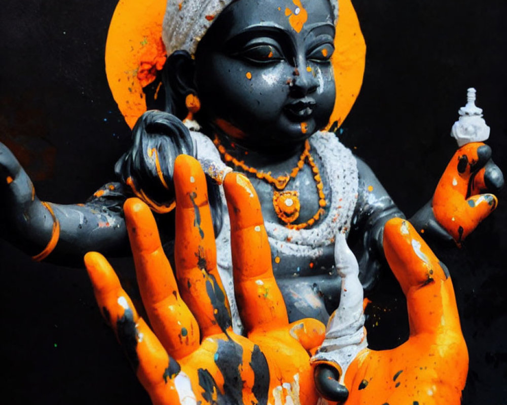 Vibrant deity statue in black and orange hues