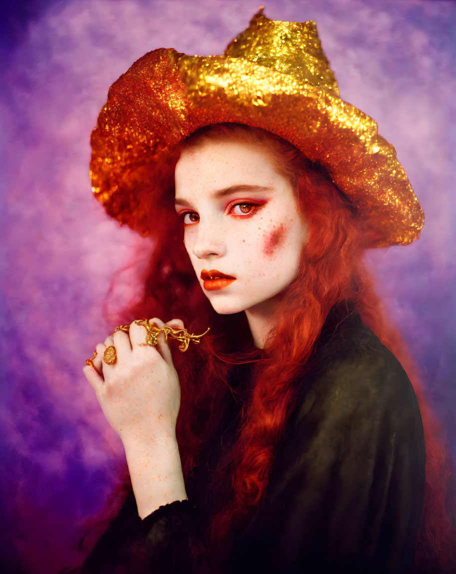 Red-haired woman in gold hat and dark coat against purple backdrop