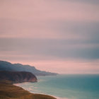 Serene Coastal Landscape with Gentle Waves and Mountains