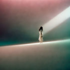 Silhouette of person in light beam amid dark and pastel gradient