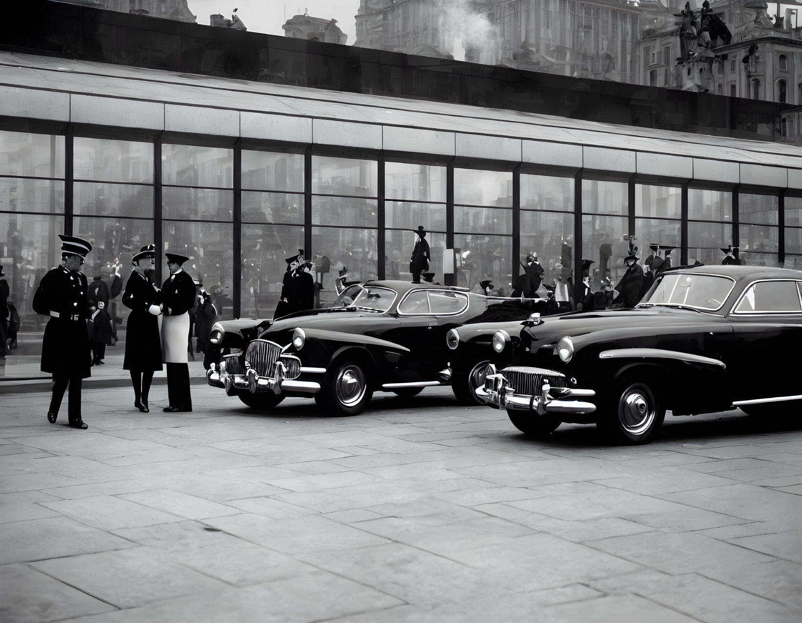 Vintage Cars and Men in Uniform with Reflective Building