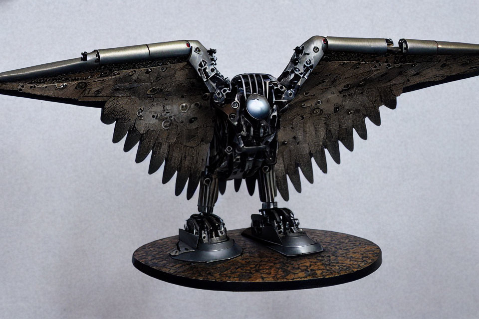 Metallic mechanical bird sculpture with widespread wings and intricate details.