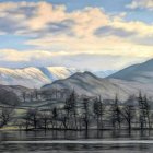 Snowy mountains, frozen lake, cozy houses, and frost-covered trees in a serene winter scene