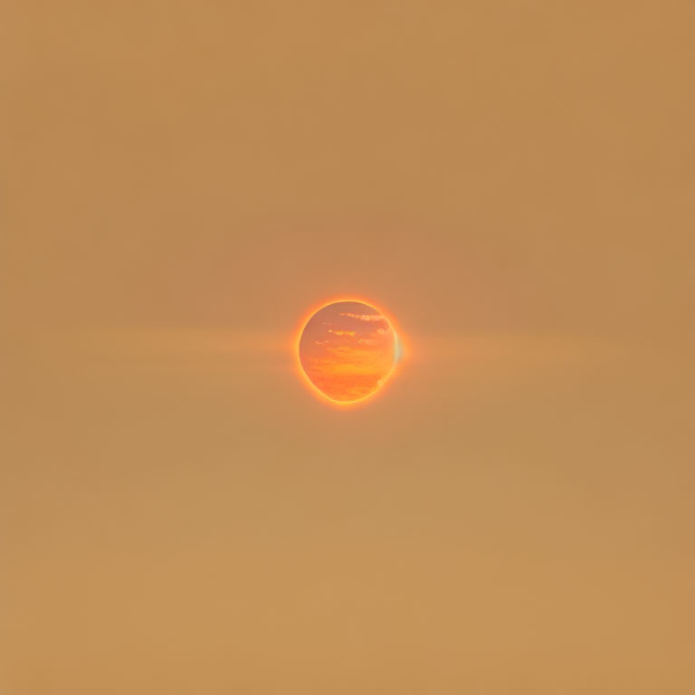 Golden-orange sunset with serene clouds in the sky