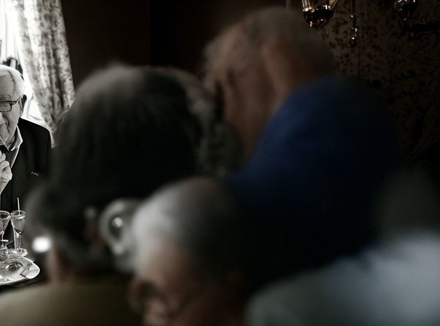 Blurry photo of elderly couple hugging in soft light