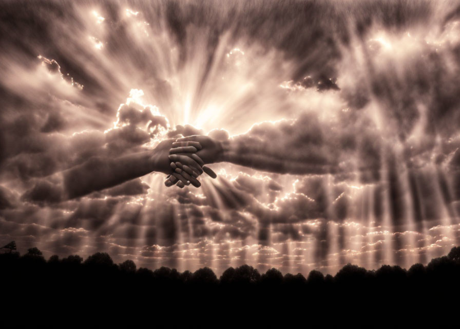 Dramatic sky with sunbeams and shaking hands