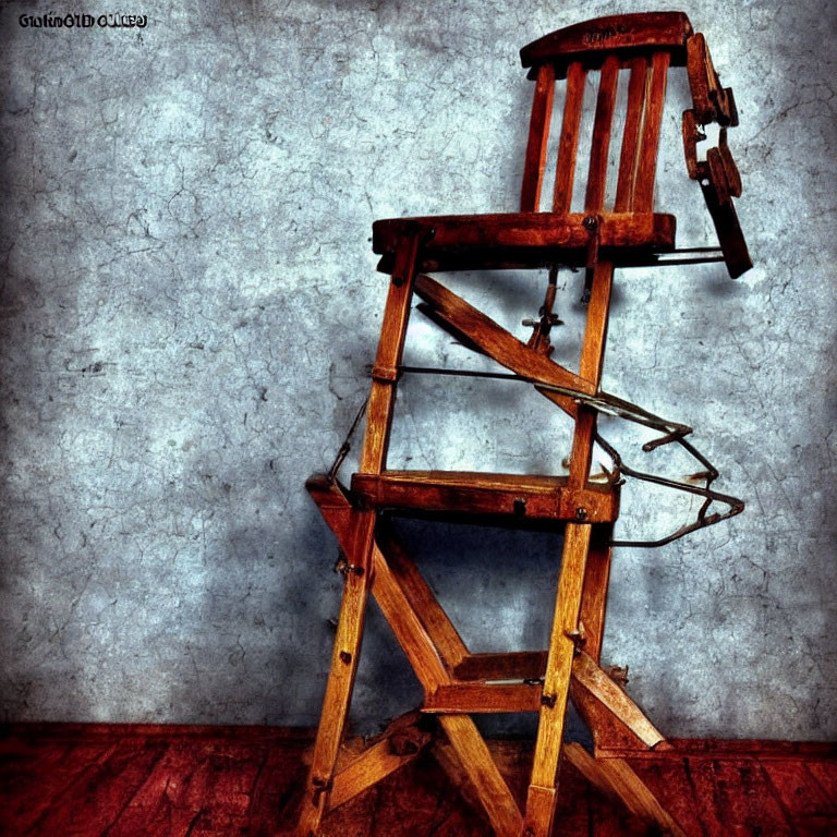 Vintage Wooden High Chair with Metal Footrest on Textured Background