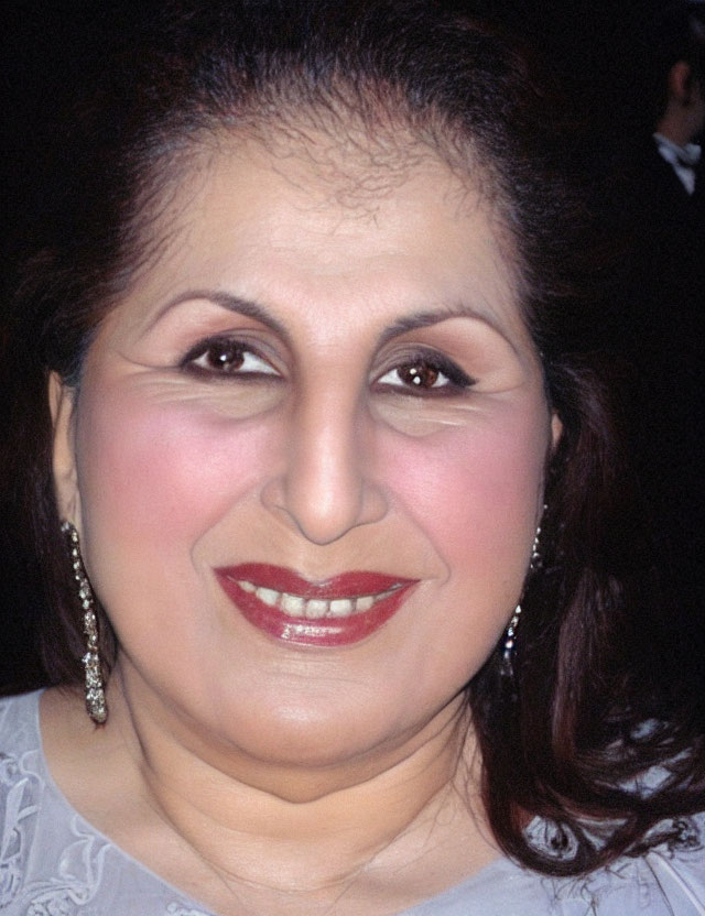 Close-up portrait of woman with red lipstick and dark eyeliner