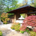 Traditional House with Red Facade in Colorful Garden