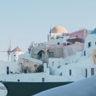 Snowy cityscape with elaborate white buildings reflected in water