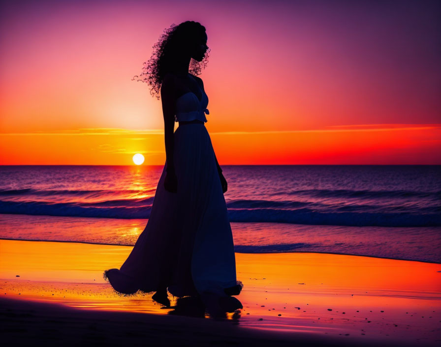 Silhouette of woman with curly hair on beach at sunset with vibrant orange and purple hues