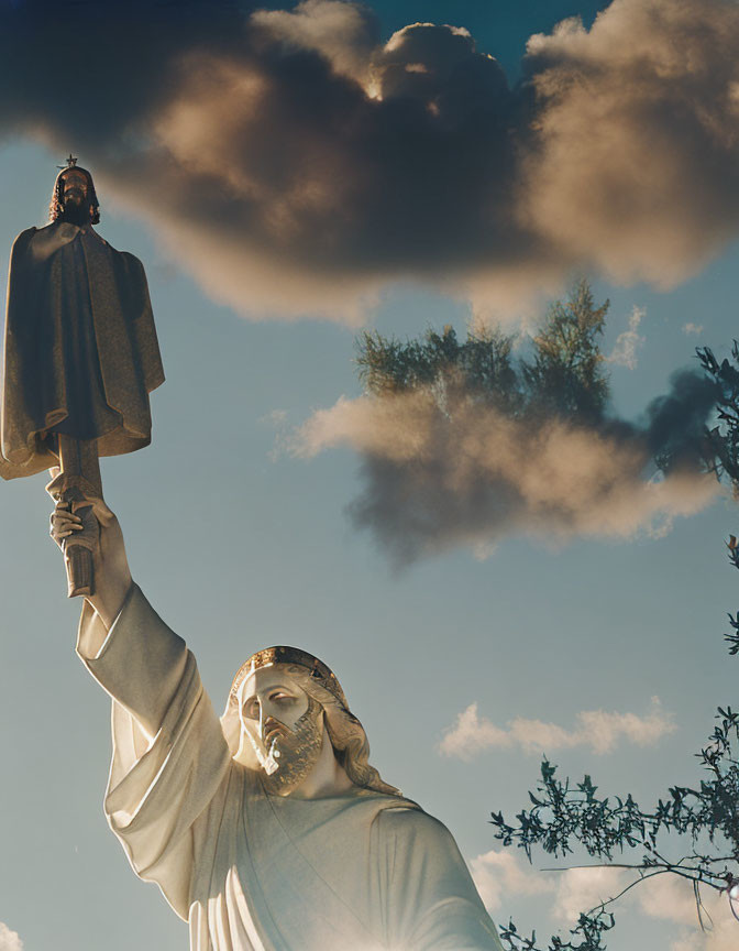 Religious statue gesturing skyward with dramatic clouds and green foliage.