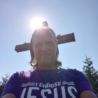 Man in Purple Robes with Cross in Sunlit Scene